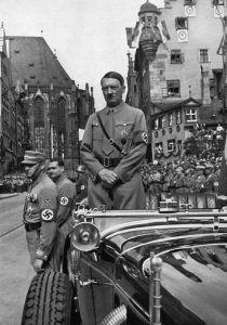 Adolf Hitler waiting for SA 'Brownshirts', Nuremberg, Germany, 1935. Hitler (1889-1945) in Nuremberg for the 7th Party Congress, named the 'Rally of Freedom' by the Nazis. A print from Adolf Hitler. Bilder aus dem Leben des Führers, Hamburg: Cigaretten/Bilderdienst Hamburg/Bahrenfeld, 1936. (Photo by The Print Collector/Print Collector/Getty Images)