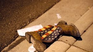 A pair of cowboy boots is shown in the street outside the concert venue after a mass shooting at a music festival on the Las Vegas Strip in Las Vegas, Nevada, U.S. October 1, 2017. REUTERS/Las Vegas Sun/Steve Marcus - RC11433BD730
